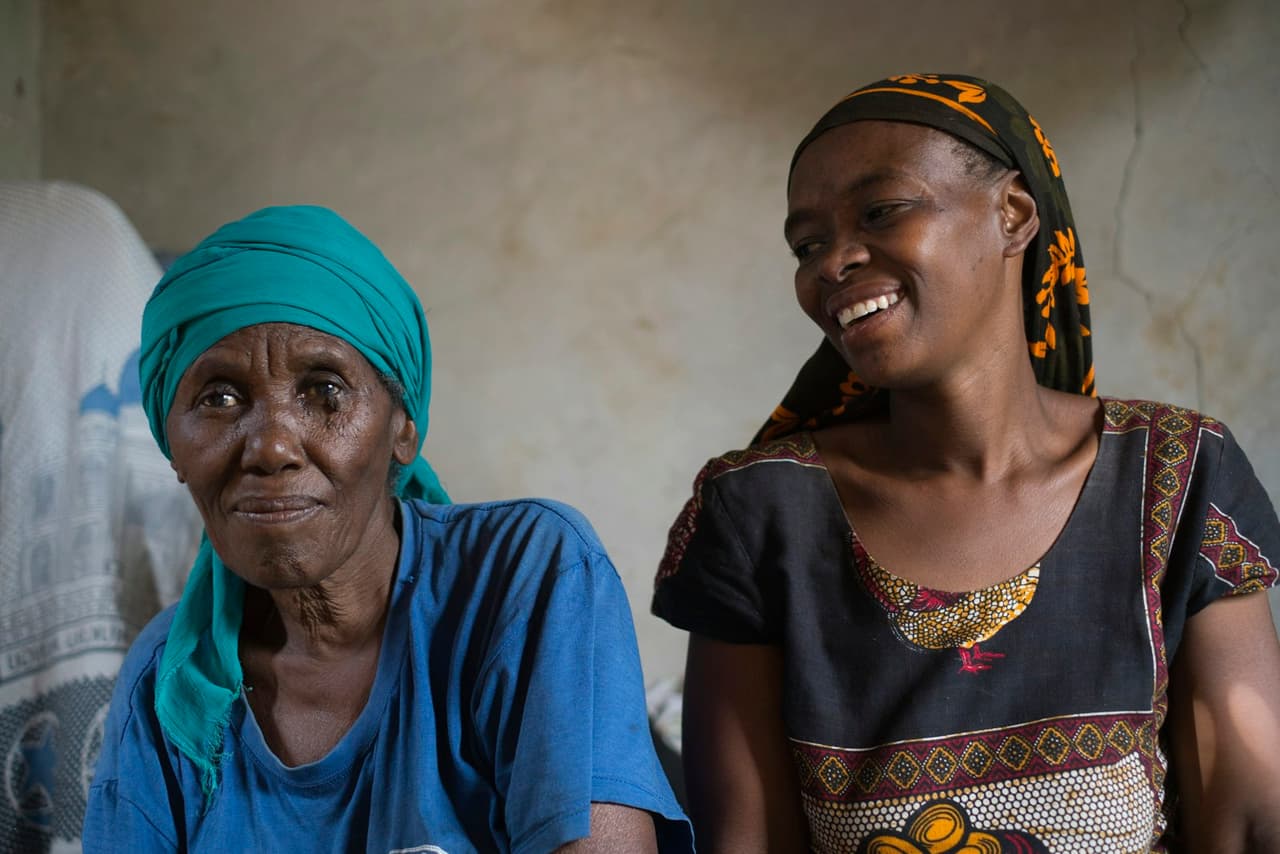 An elderly woman at home with the caregiver who visits her