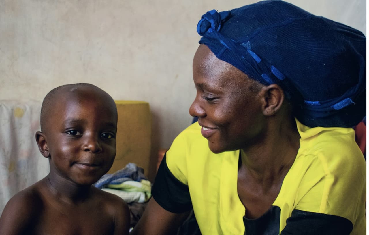 A caregiver looking after a young child at home